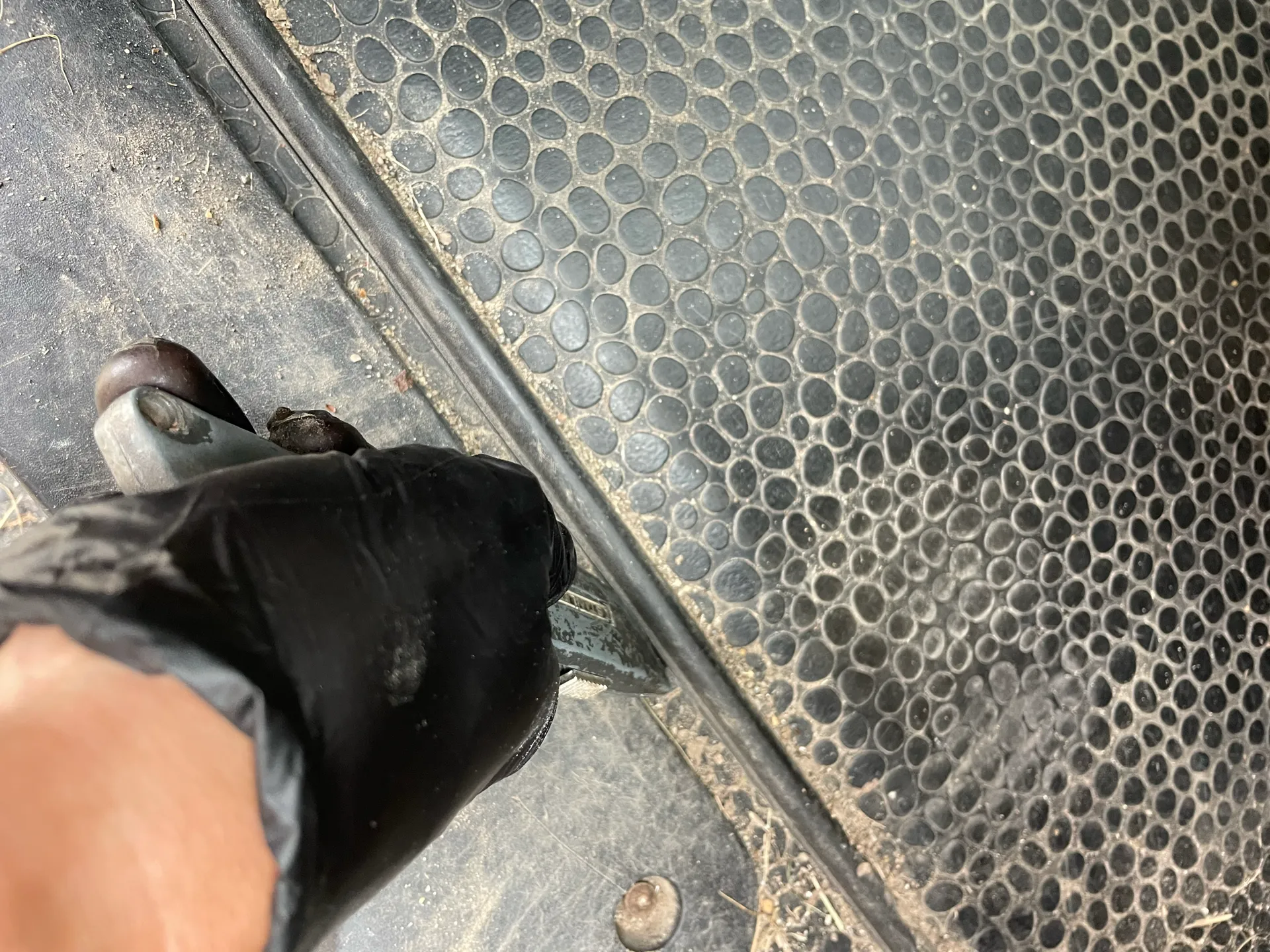 Taking a knife to the rubber floor of the van